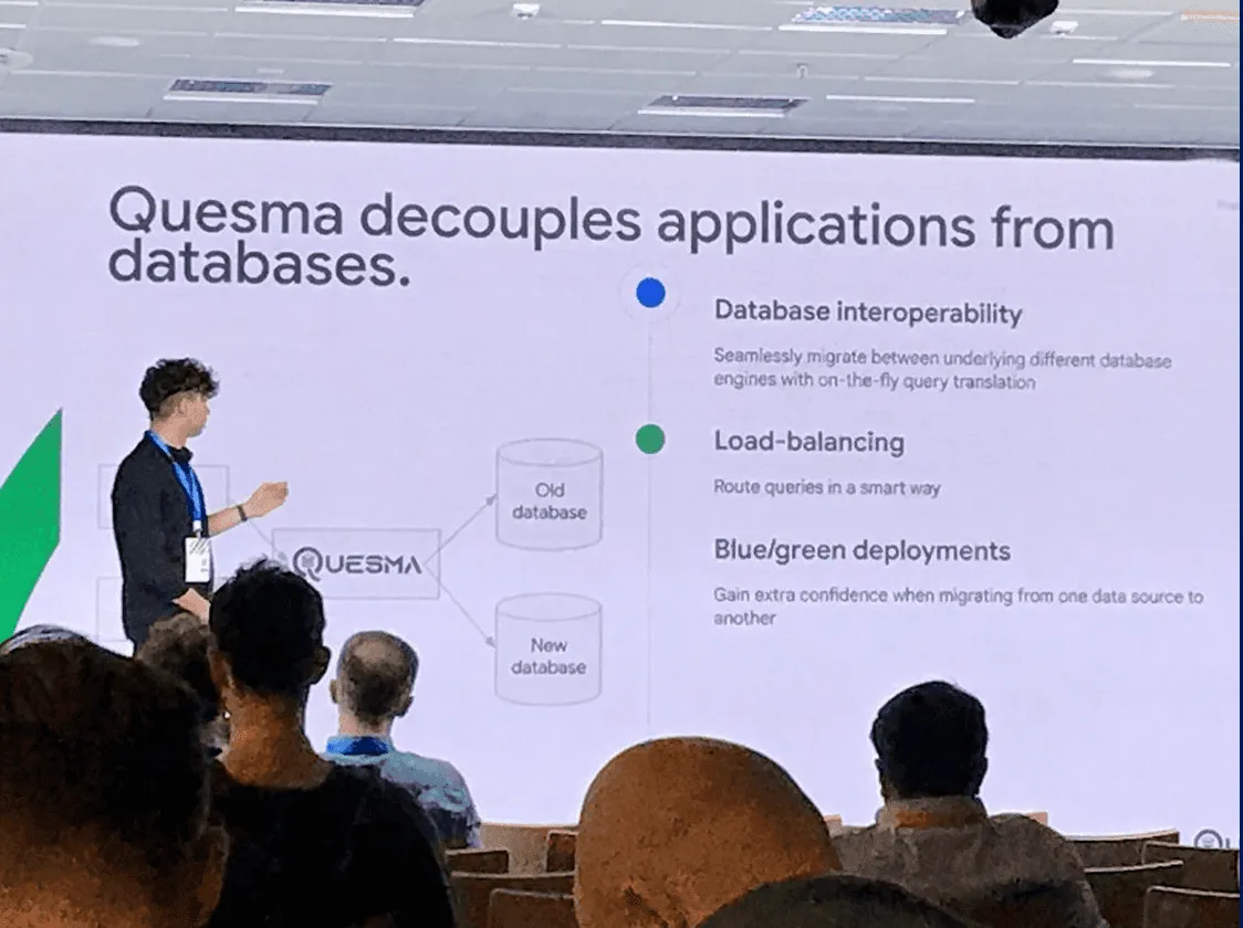 Speaker presenting Quesma’s database gateway features to an audience at Google Cloud Summit.